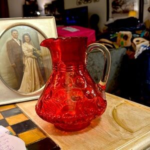Cranberry colored fento glass pitcher vintage.